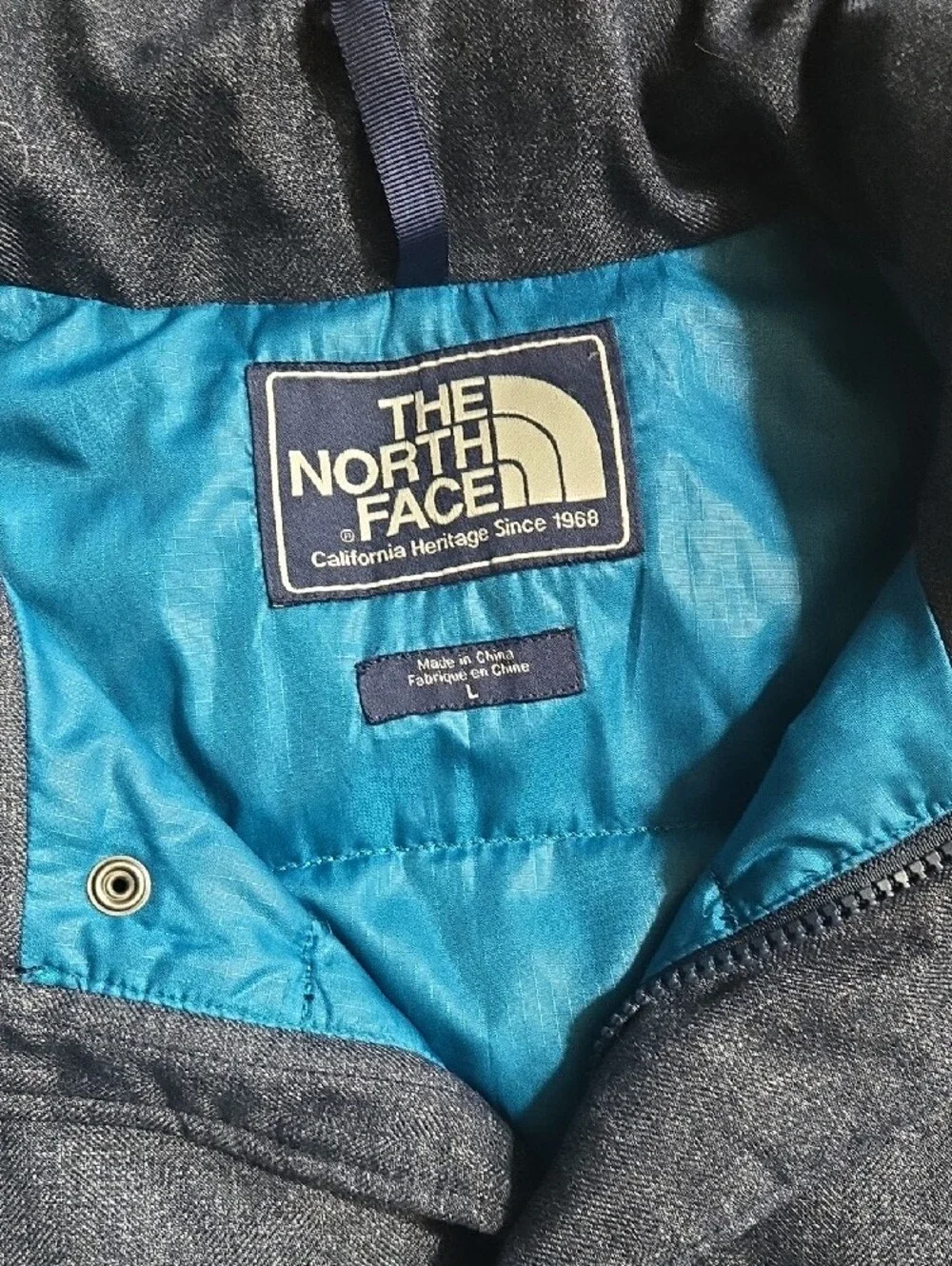The North Face Men’s Heather Navy Puffer Vest with Bright Blue Lining Large